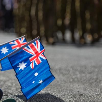 Australian flags being held at a parade