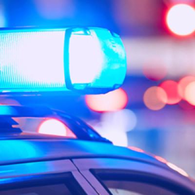 Red and blue flashing lights atop of an emergency service vehicle.